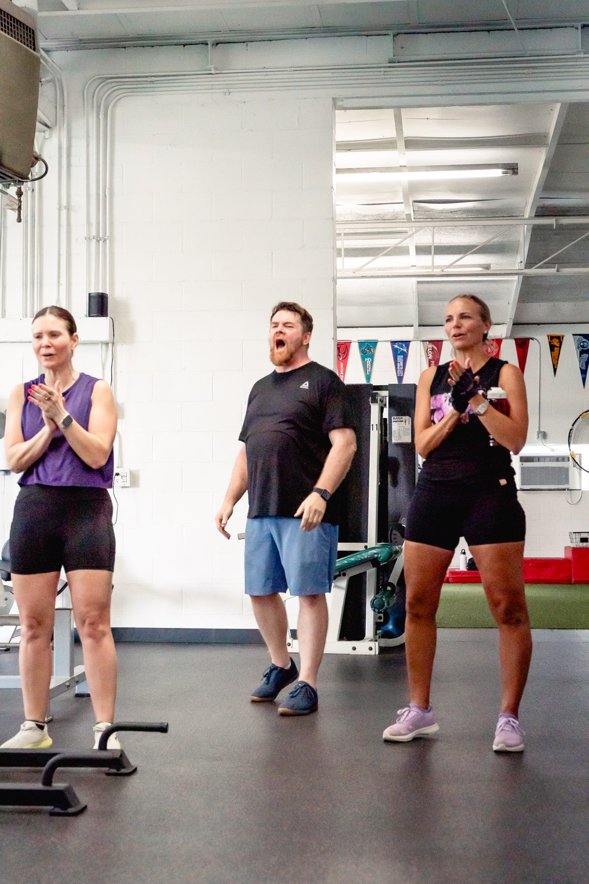 Adult members cheering each other on at The Strength Feed in Raleigh